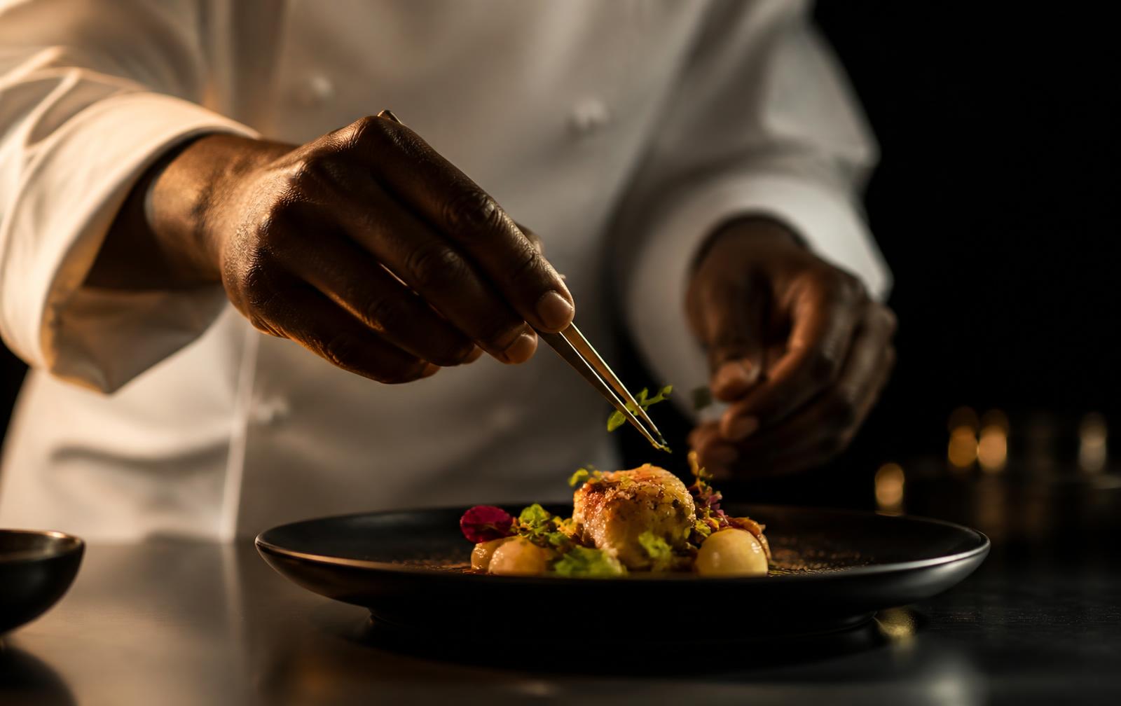 Chef Sethu plating a fine dining dish